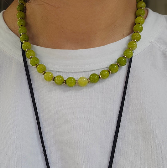 Green beaded necklace on a white shirt
