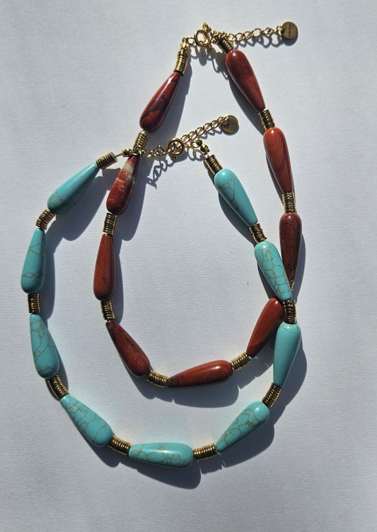 2 necklaces. One is turquoise, the other red jasper.