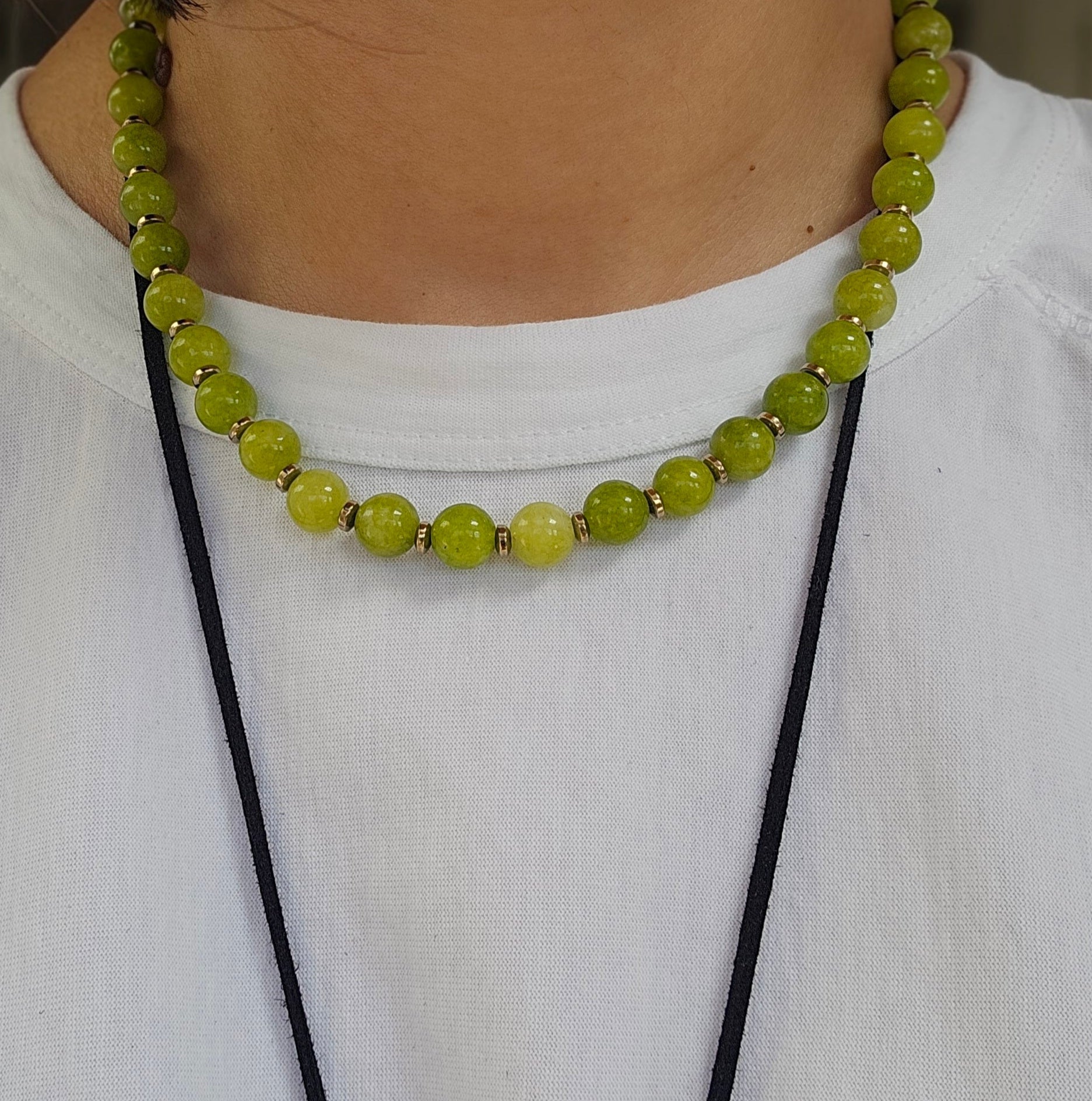 Green beaded necklace on a white shirt