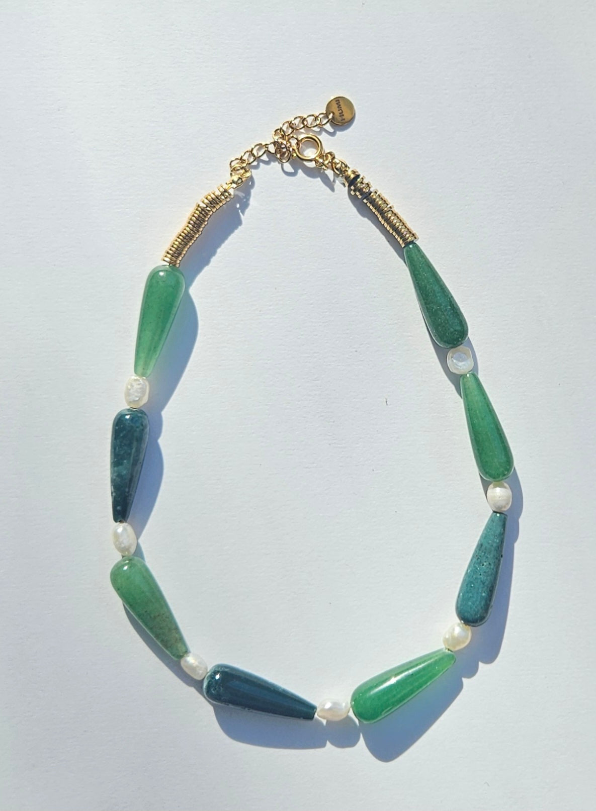 Green beaded necklace with pearls.