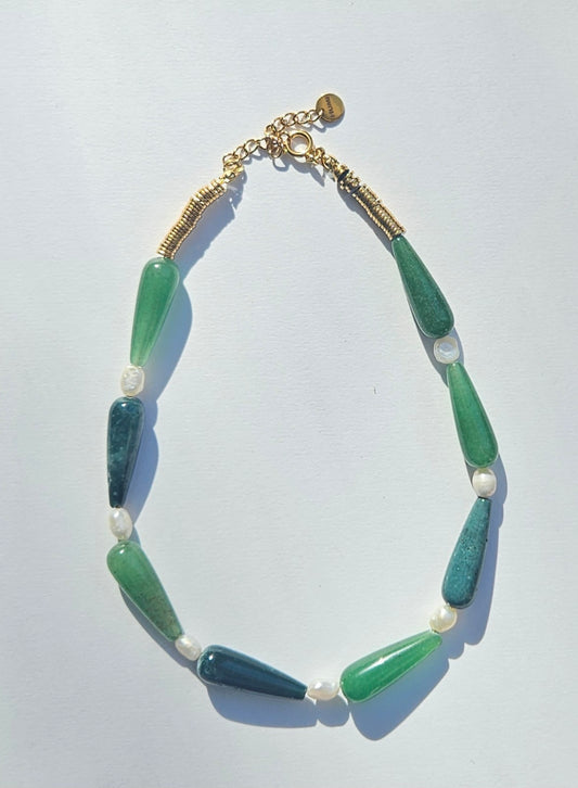 Green beaded necklace with pearls.