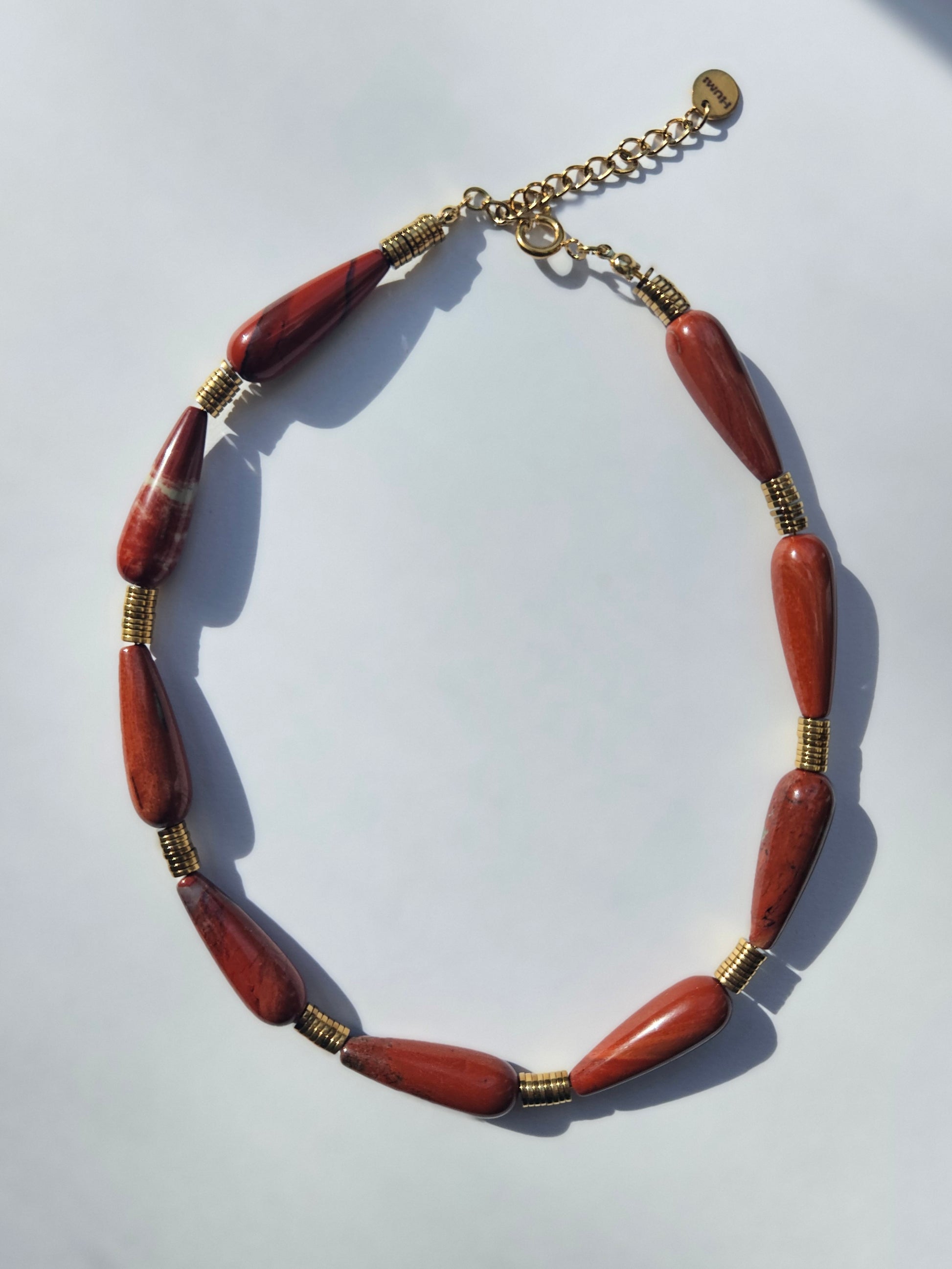 Necklace made of red jasper and gold filled discs.