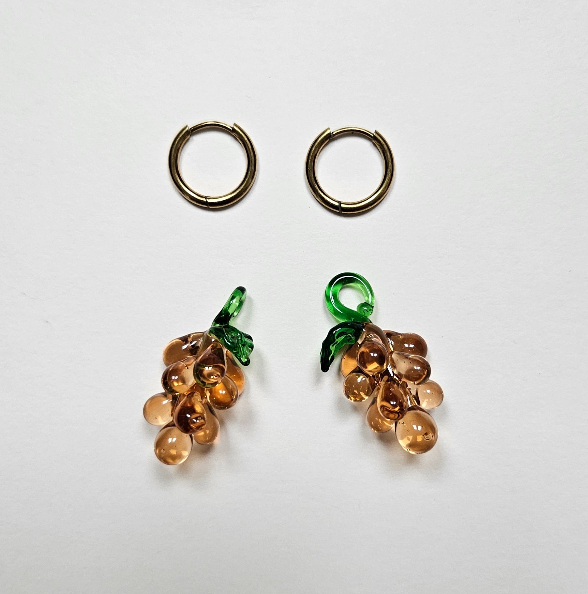 Pair of grape-shaped earrings on a white background
