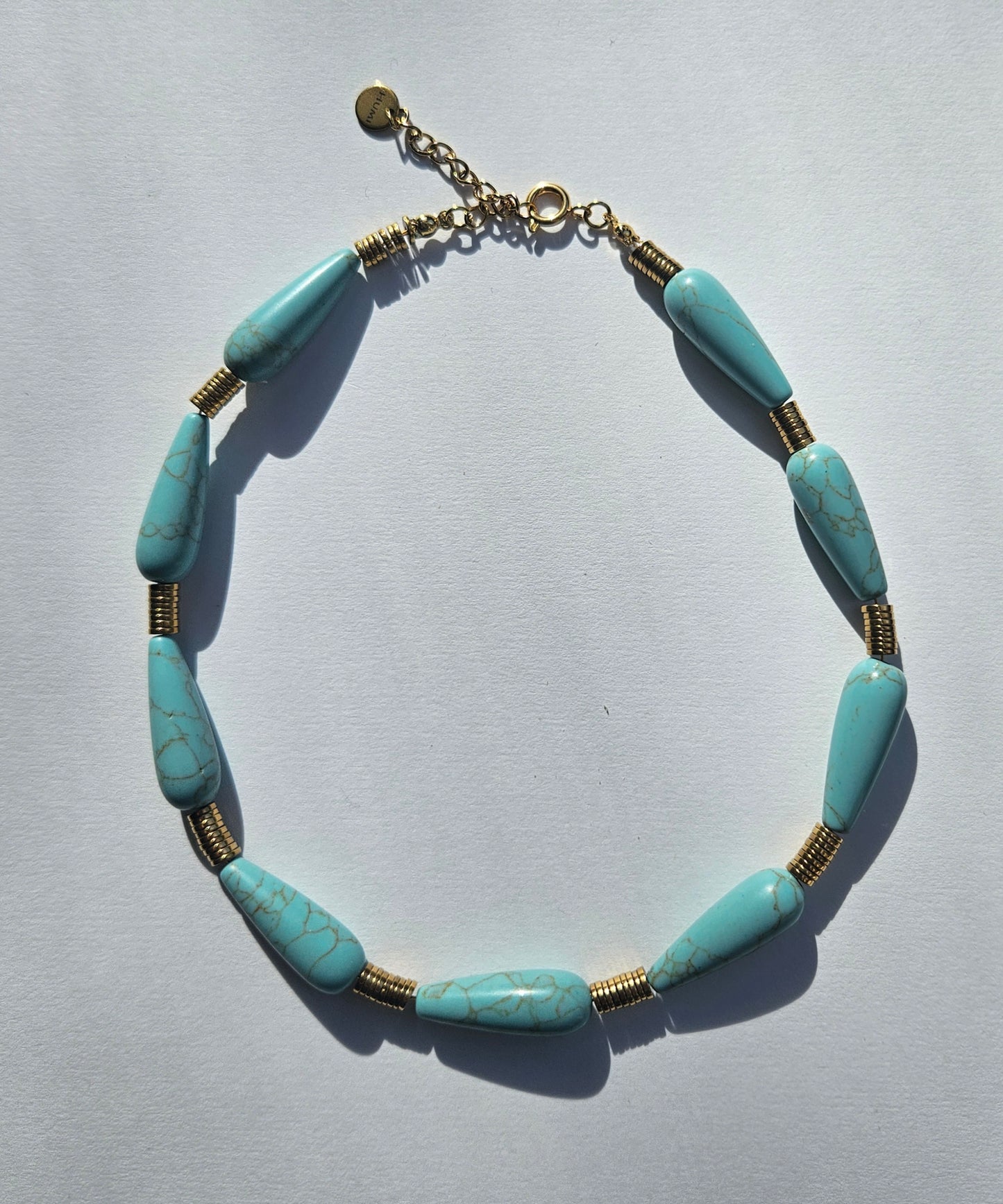Necklace made of turquoise and gold filled discs. 