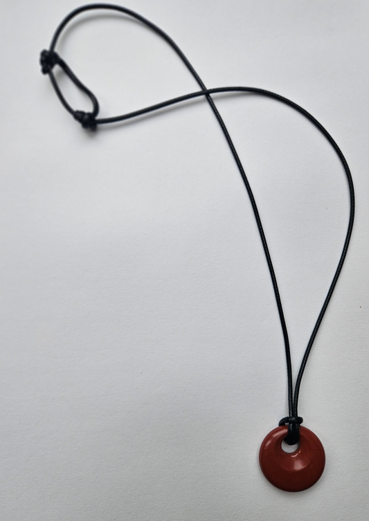 Necklace with a red pendant on a white background