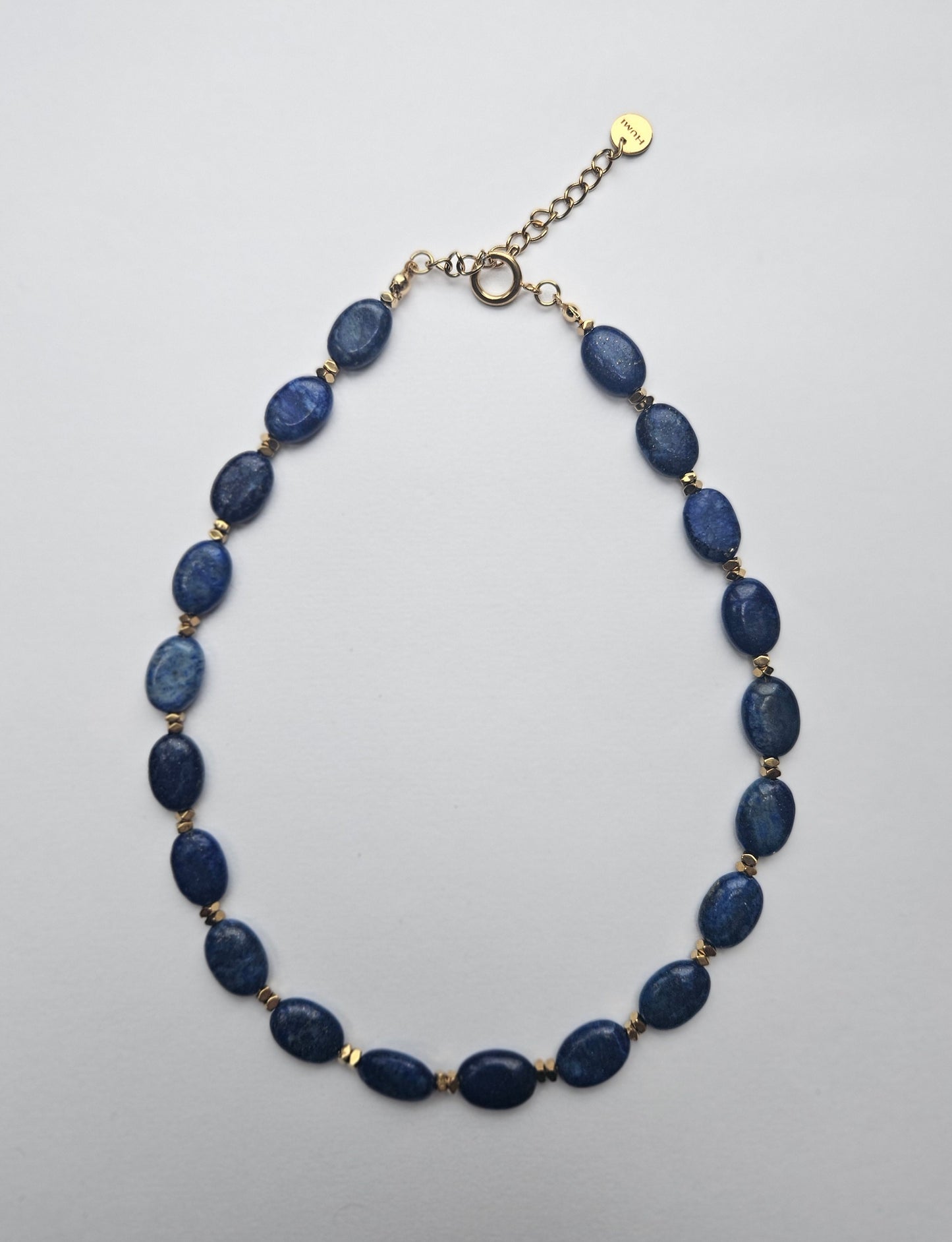 Necklace with blue beads on a light gray background