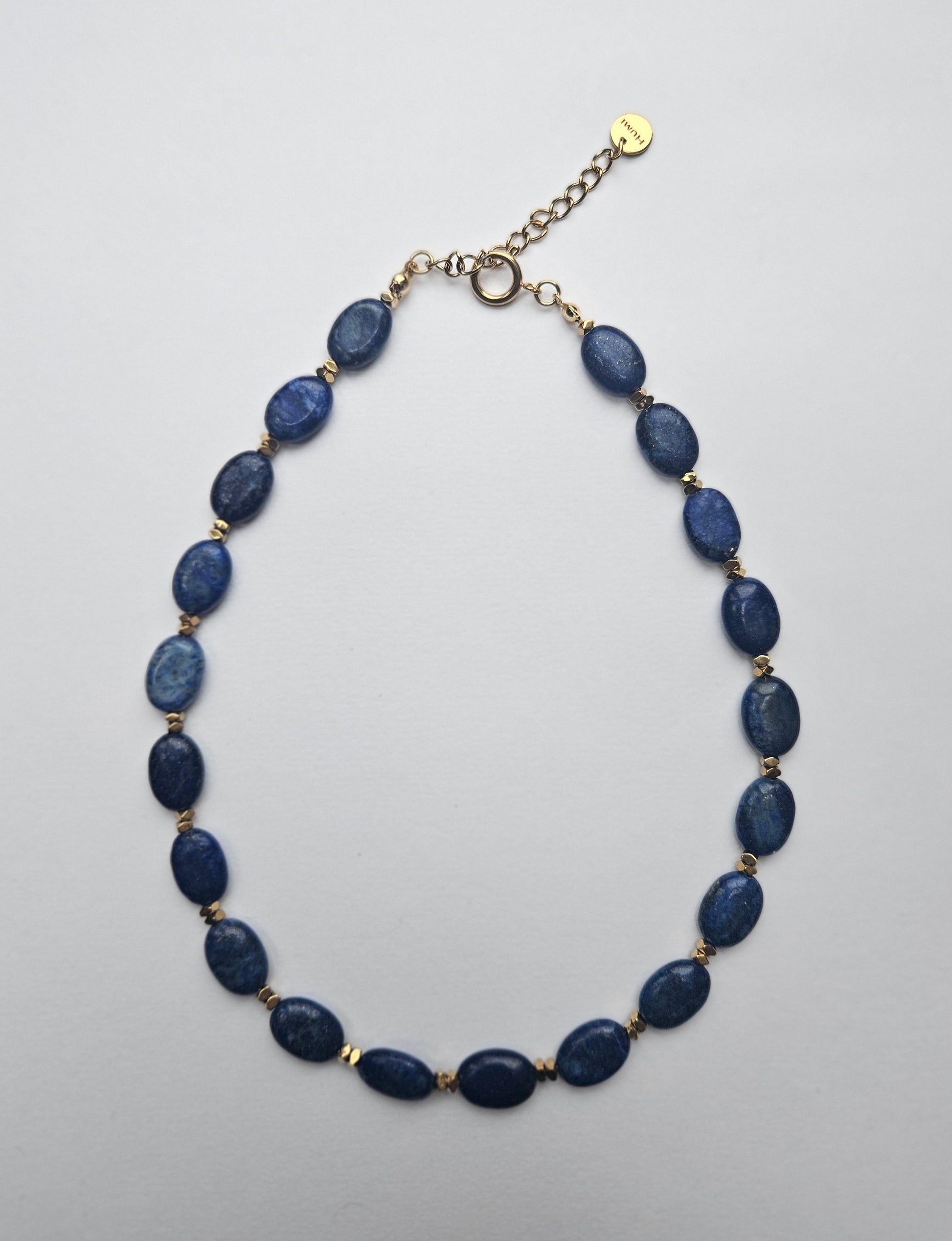 Necklace with blue beads on a light gray background