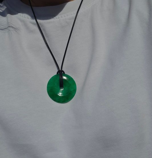 Green pendant necklace on a white shirt