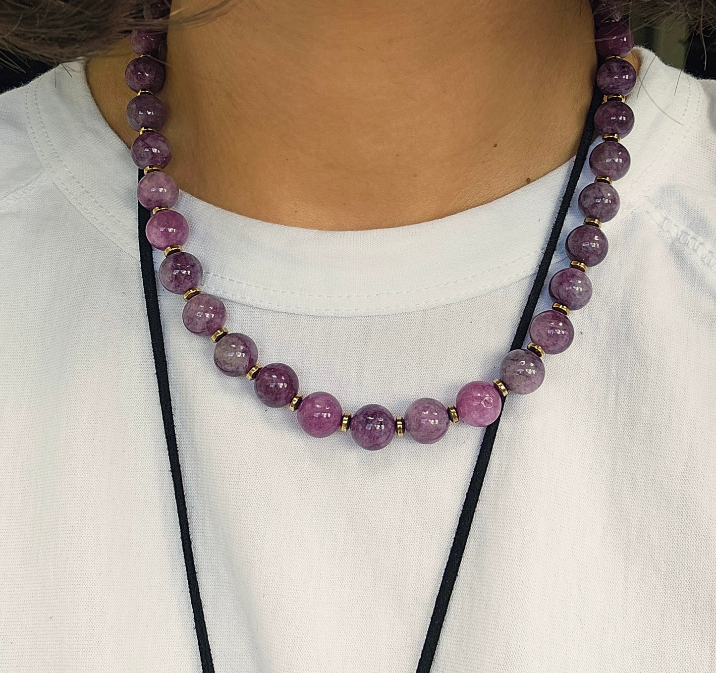 Purple beaded necklace on a white shirt
